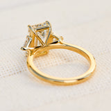 emerald cut lab grown diamond trilogy engagement ring set in yellow gold