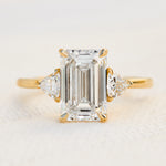 emerald cut lab grown diamond trilogy engagement ring set in yellow gold