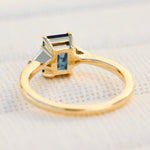 emerald cut sapphire trilogy engagement ring in yellow gold
