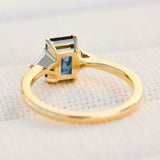 emerald cut sapphire trilogy engagement ring in yellow gold