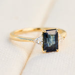 emerald cut sapphire trilogy engagement ring in yellow gold