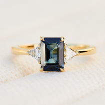 emerald cut sapphire trilogy engagement ring in yellow gold