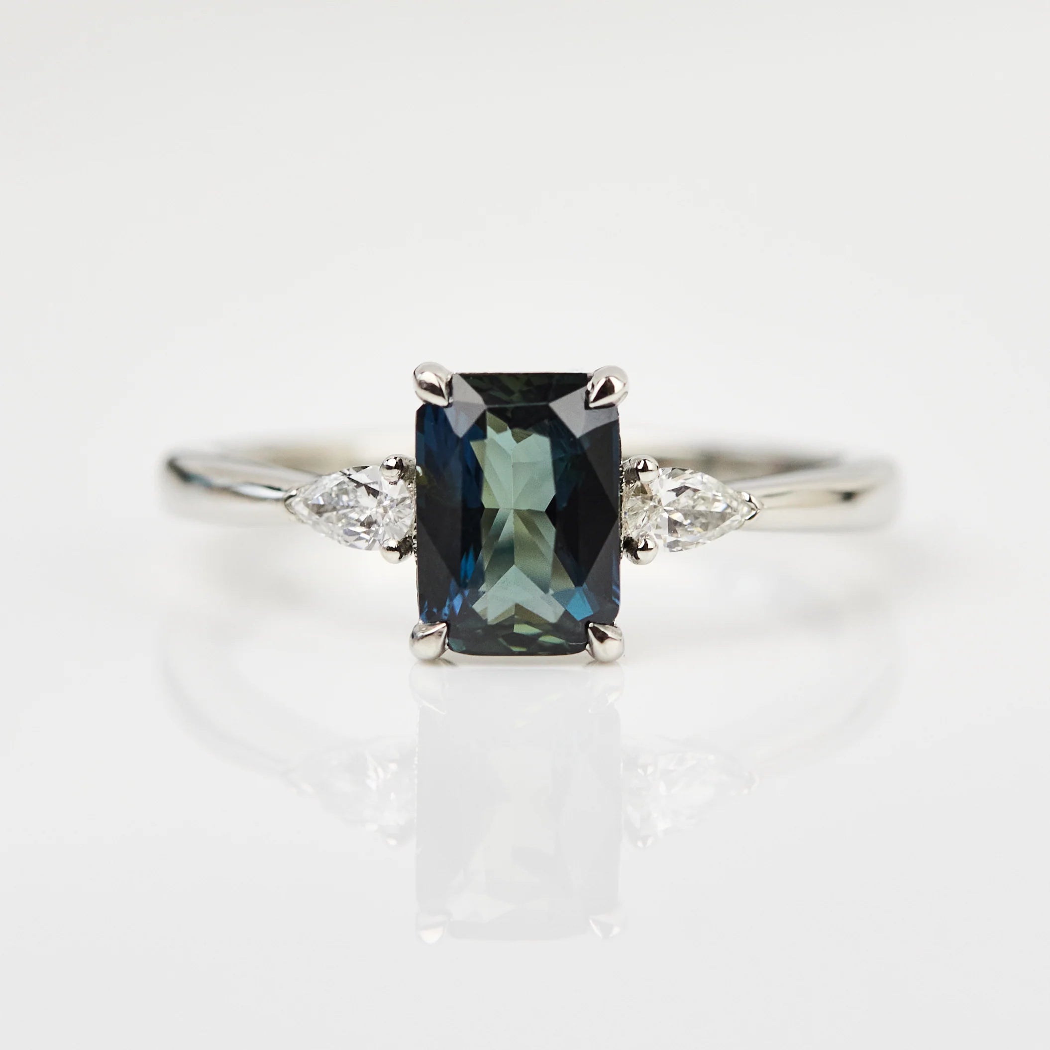 emerald cut teal blue sapphire engagement ring