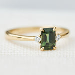 emerald cut green sapphire ring in yellow gold