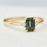 emerald cut green sapphire ring in yellow gold