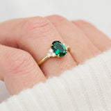 oval emerald yellow gold engagement ring with six round side diamonds