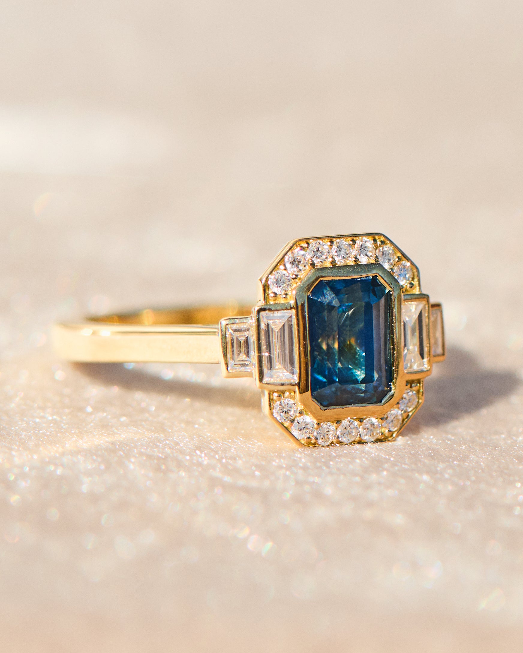 emerald cut blue sapphire one of a kind engagement ring in yellow gold