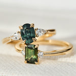 green oval and emerald cut sapphire rings in yellow gold