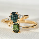 green oval and emerald cut sapphire rings in yellow gold