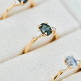 green teal oval sapphire ring in yellow gold