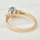blue sapphire yellow gold trilogy engagement ring