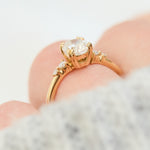 cushion cut moissanite and diamond engagement ring in yellow gold