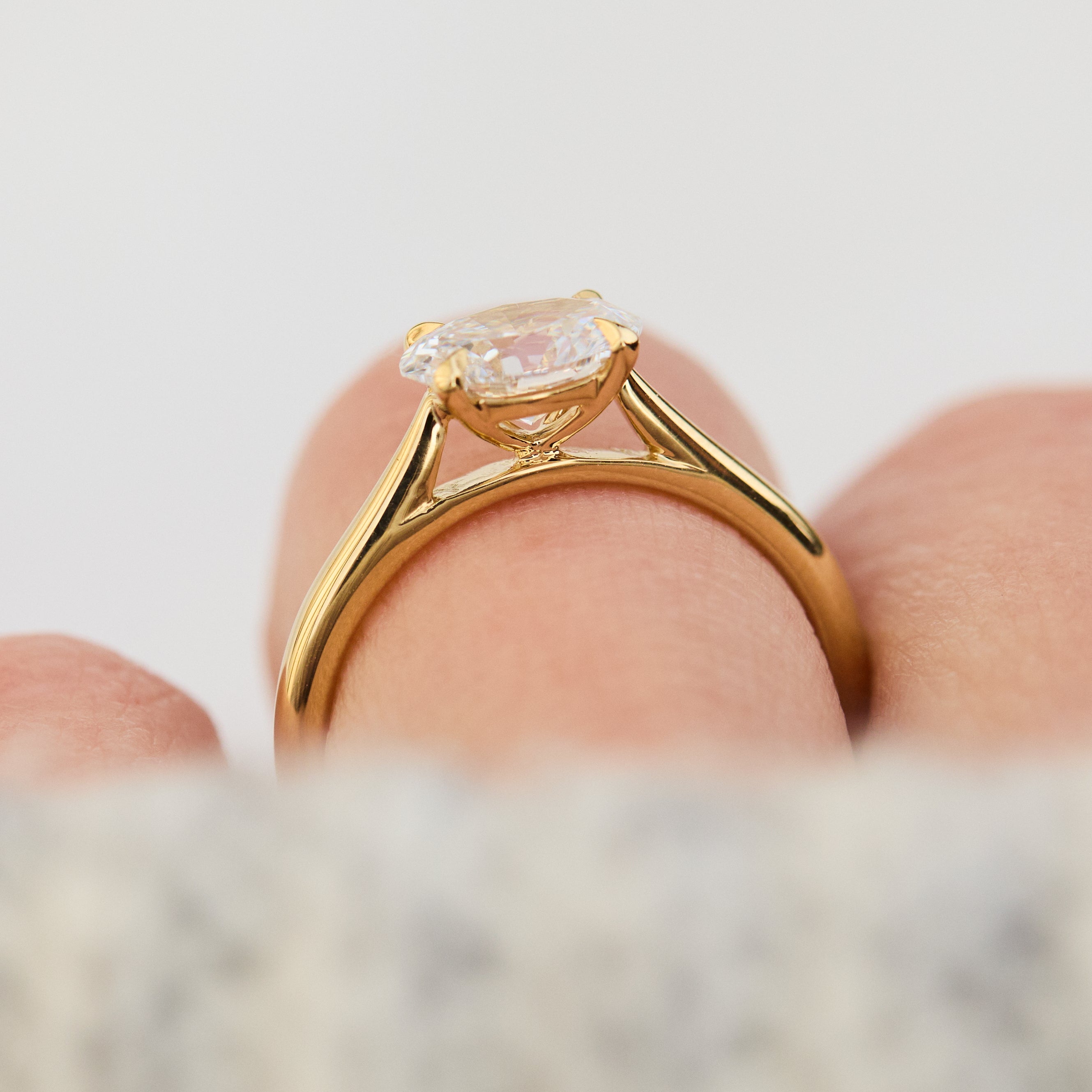 east west oval lab grown diamond engagement ring in yellow gold