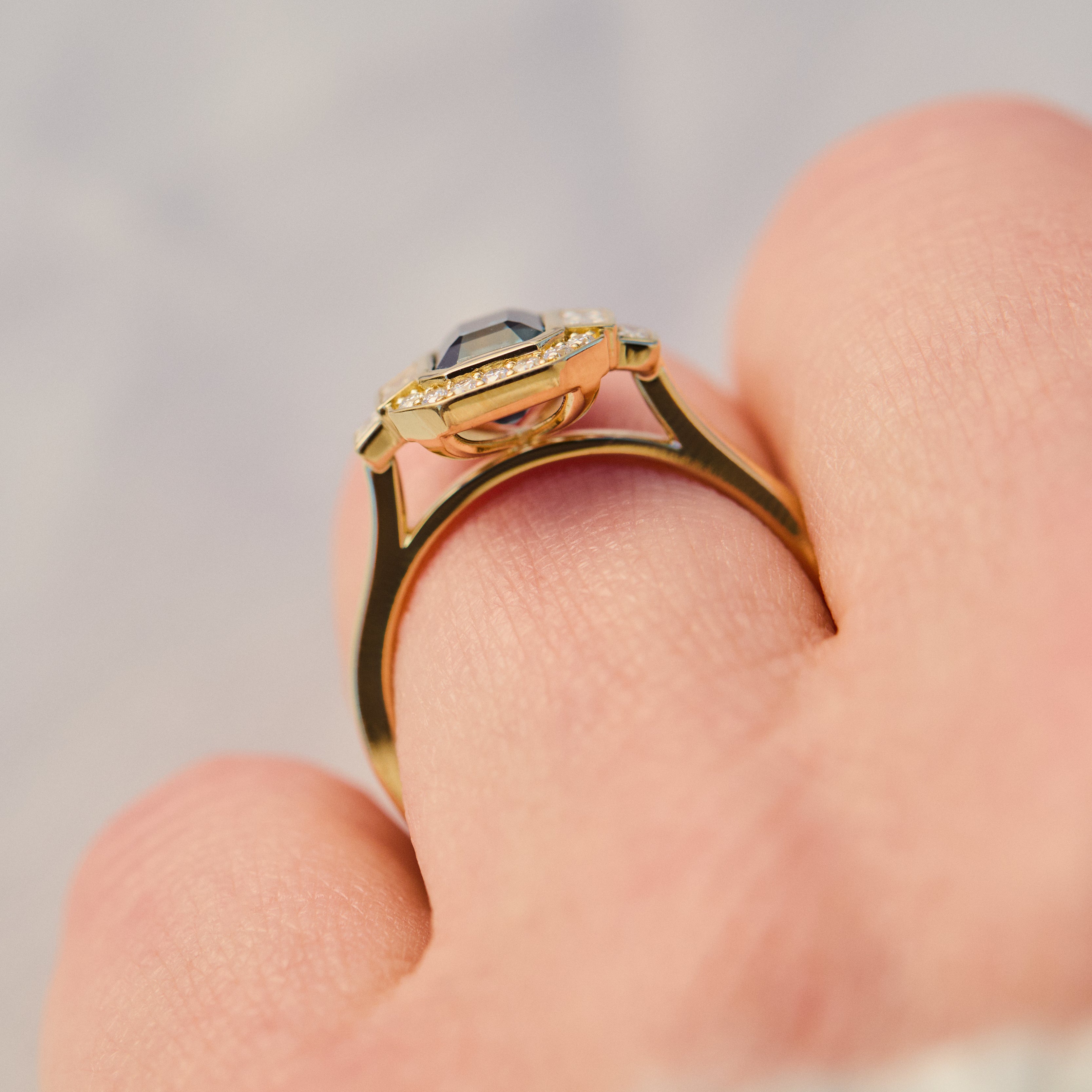 emerald cut blue sapphire one of a kind engagement ring in yellow gold