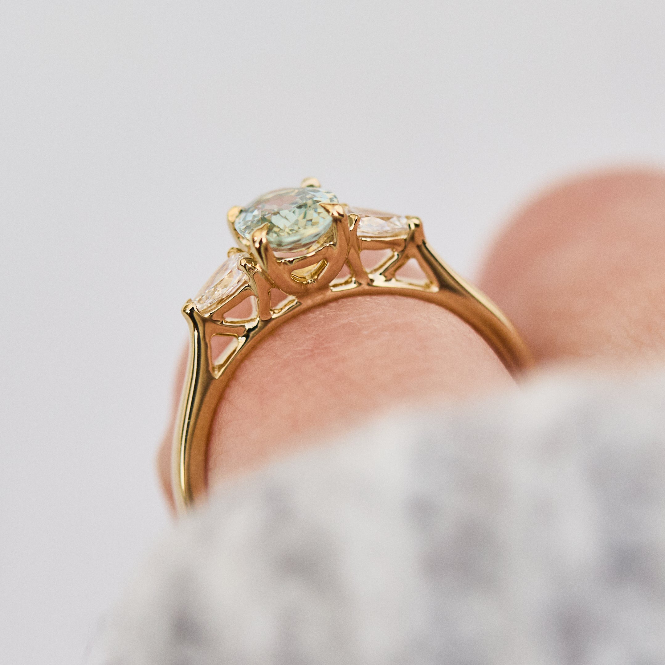 montana oval sapphire trilogy yellow gold engagement ring