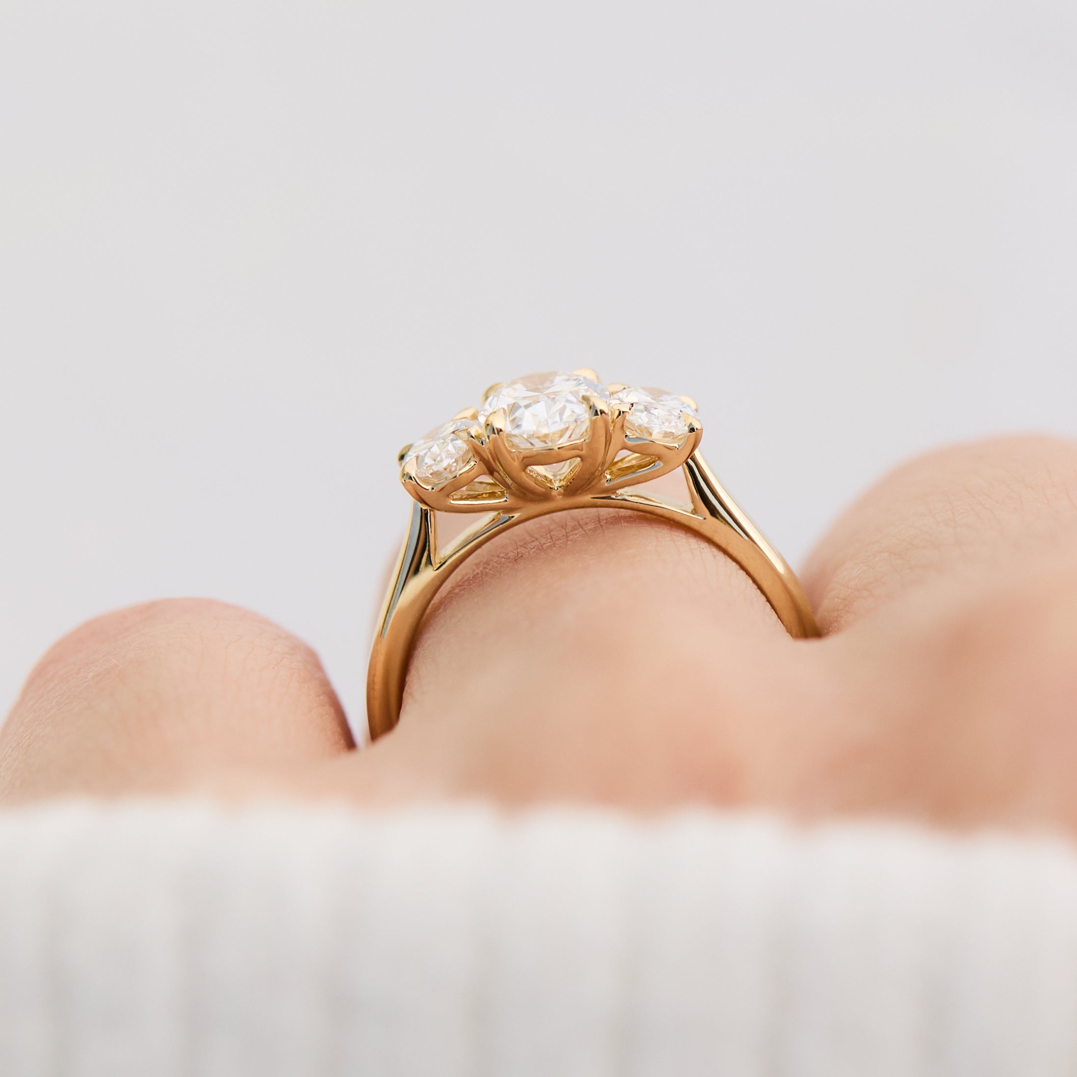oval diamonds trilogy engagement ring set in 18ct yellow gold