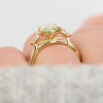 oval green lab grown diamond trilogy engagement ring in yellow gold