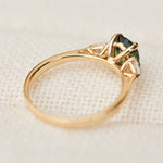 oval green teal sapphire trilogy engagement ring in yellow gold