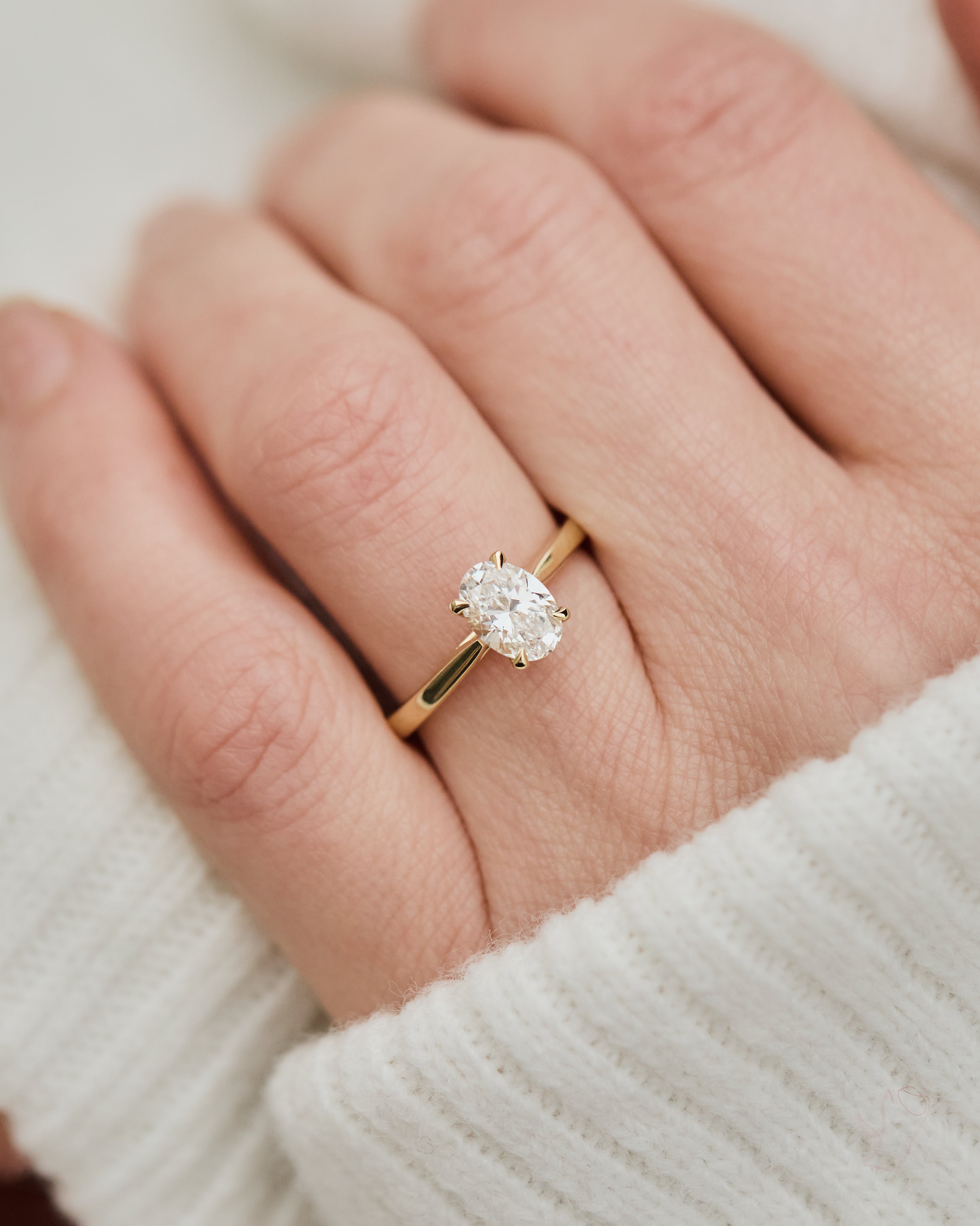 oval lab grown diamond engagement ring in yellow gold