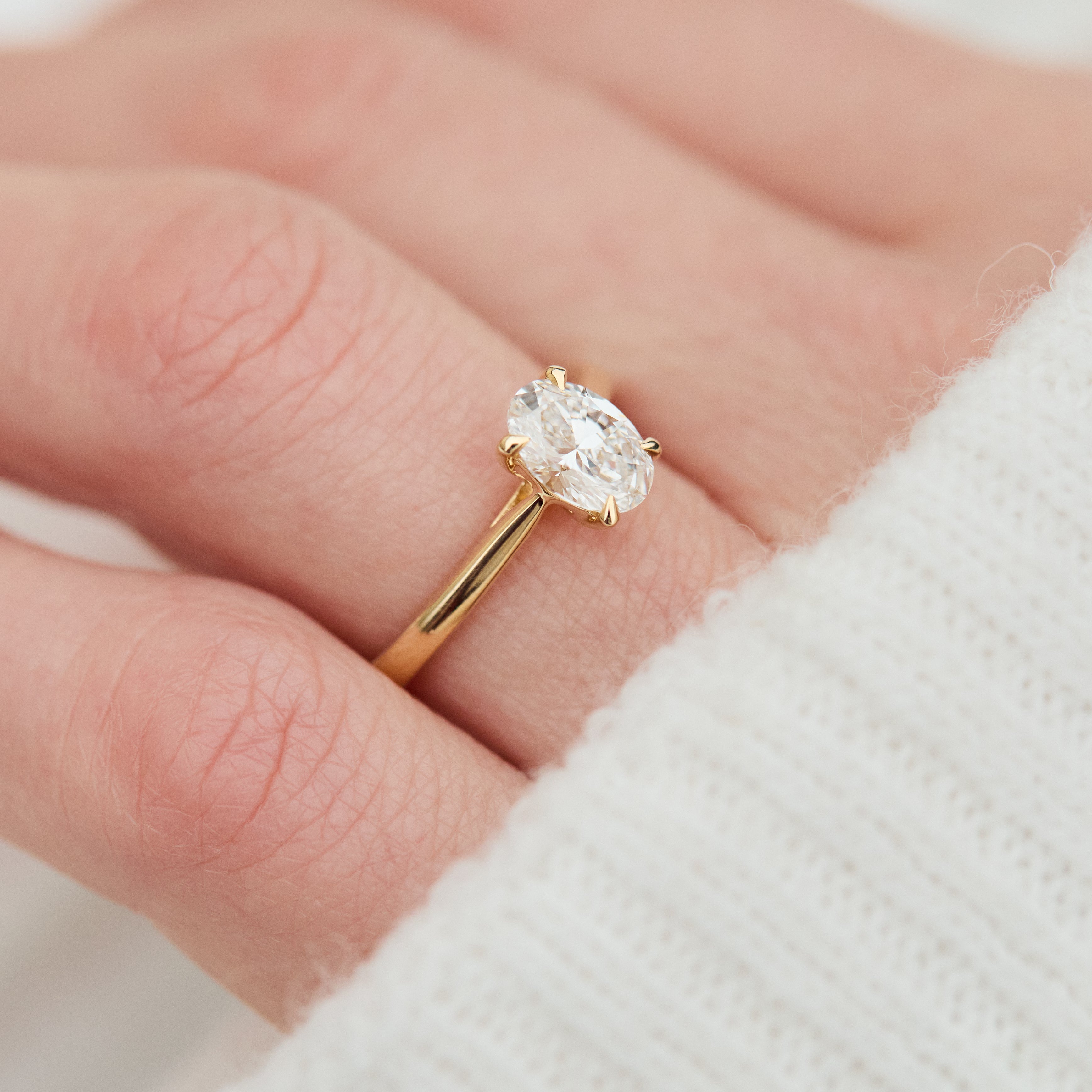 oval lab grown diamond engagement ring in yellow gold