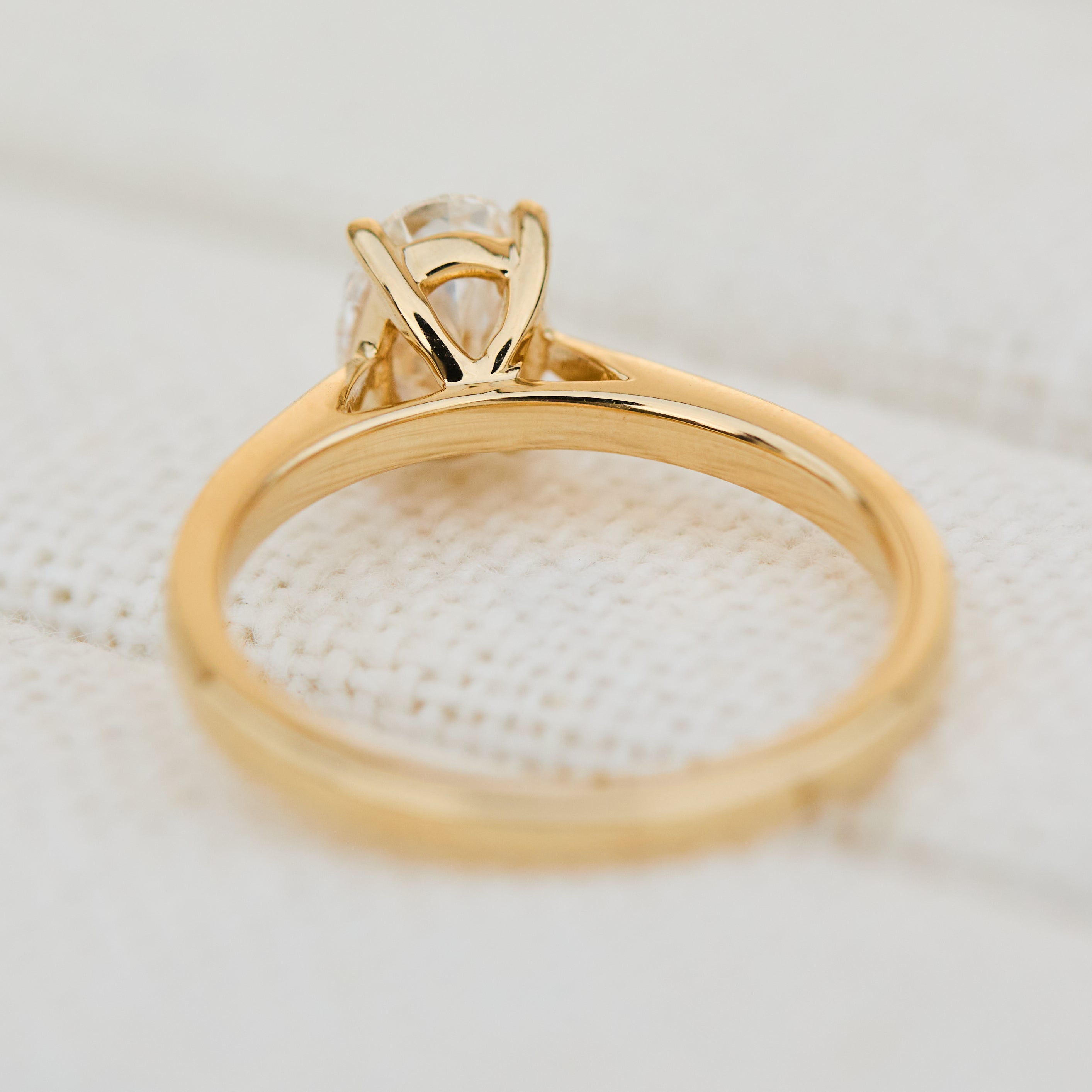 oval lab grown diamond engagement ring in yellow gold