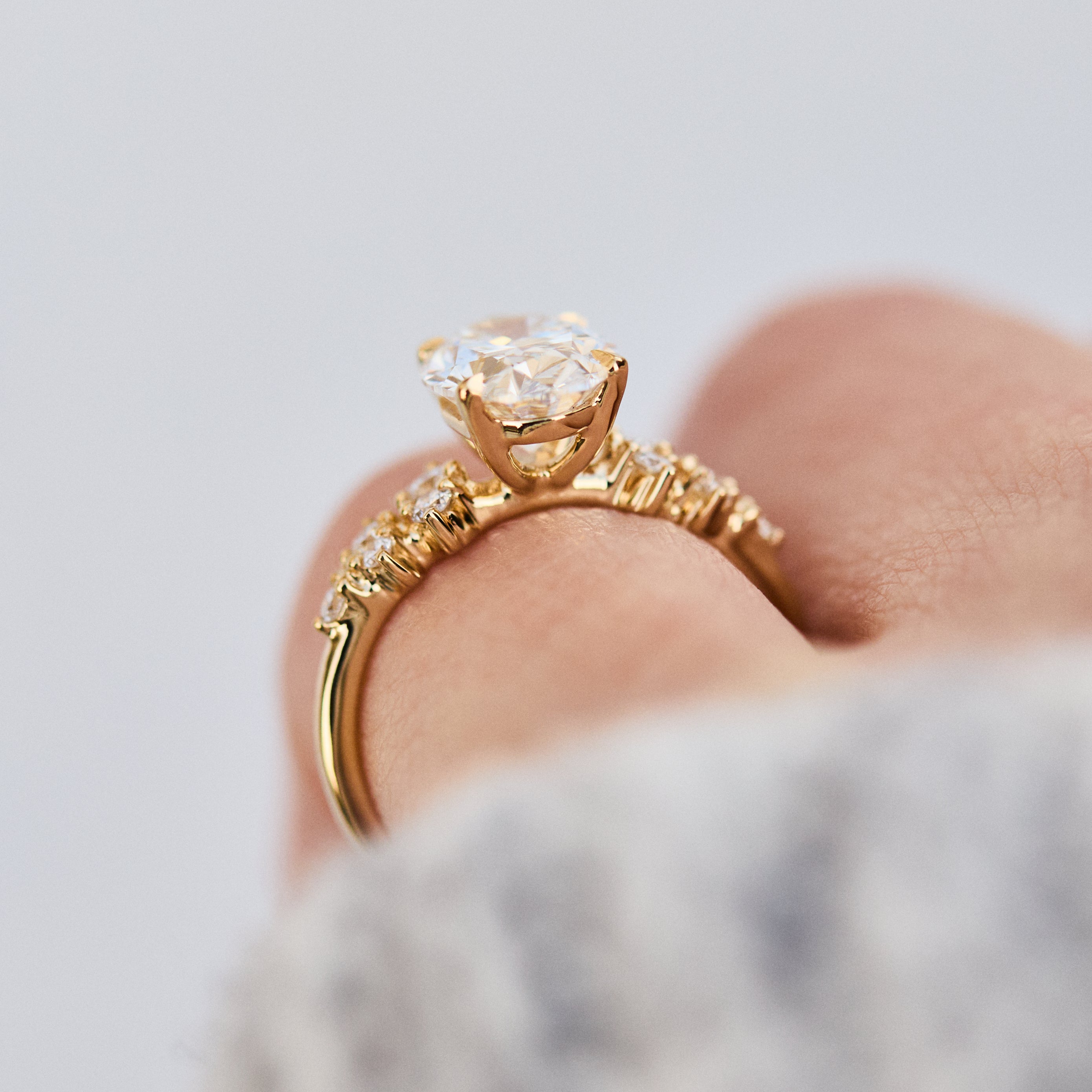 oval lab grown diamond yellow gold engagement cluster ring