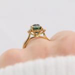 oval sapphire trilogy engagement ring in yellow gold