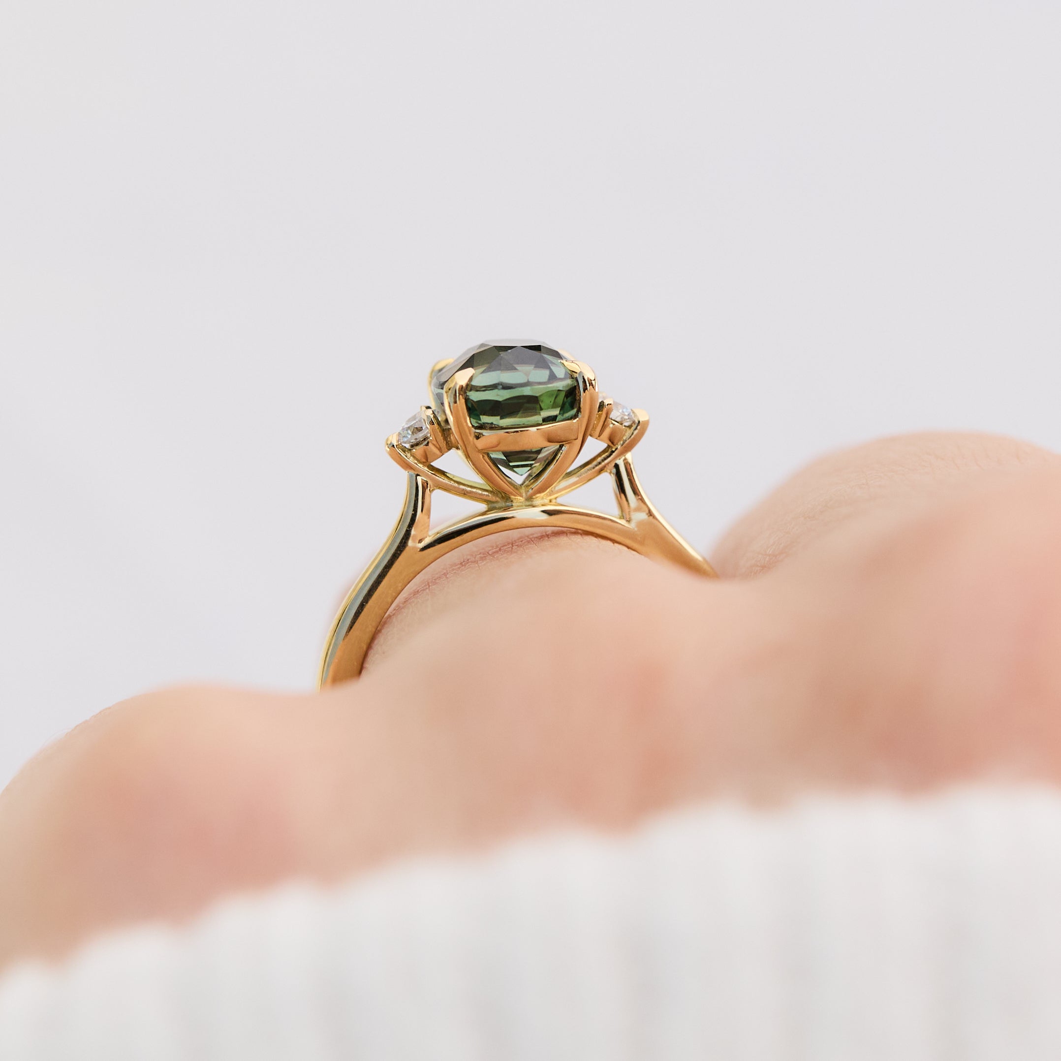oval sapphire trilogy engagement ring in yellow gold