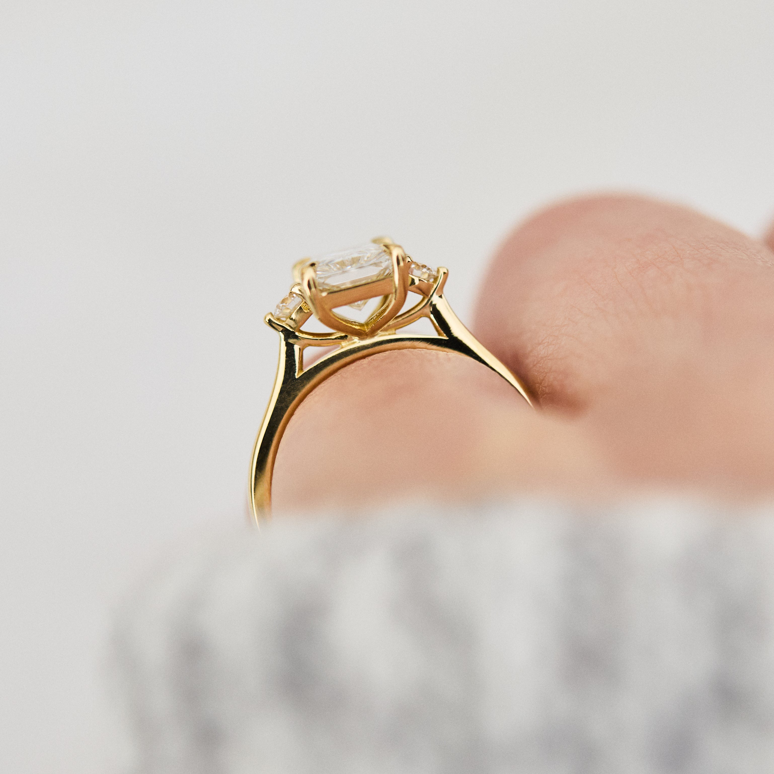 radiant cut lab grown diamond trilogy engagement ring in yellow gold
