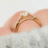 round brilliant cut diamond trilogy engagement ring with tapered baguette shoulders