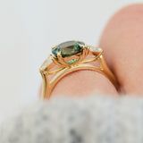 round brilliant cut madagascan teal sapphire trilogy engagement ring