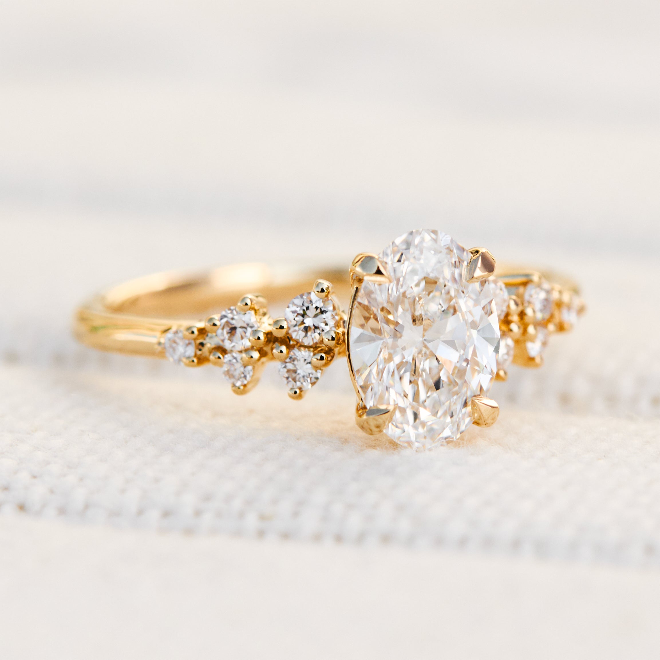 oval lab grown diamond engagement ring set in timeless yellow gold