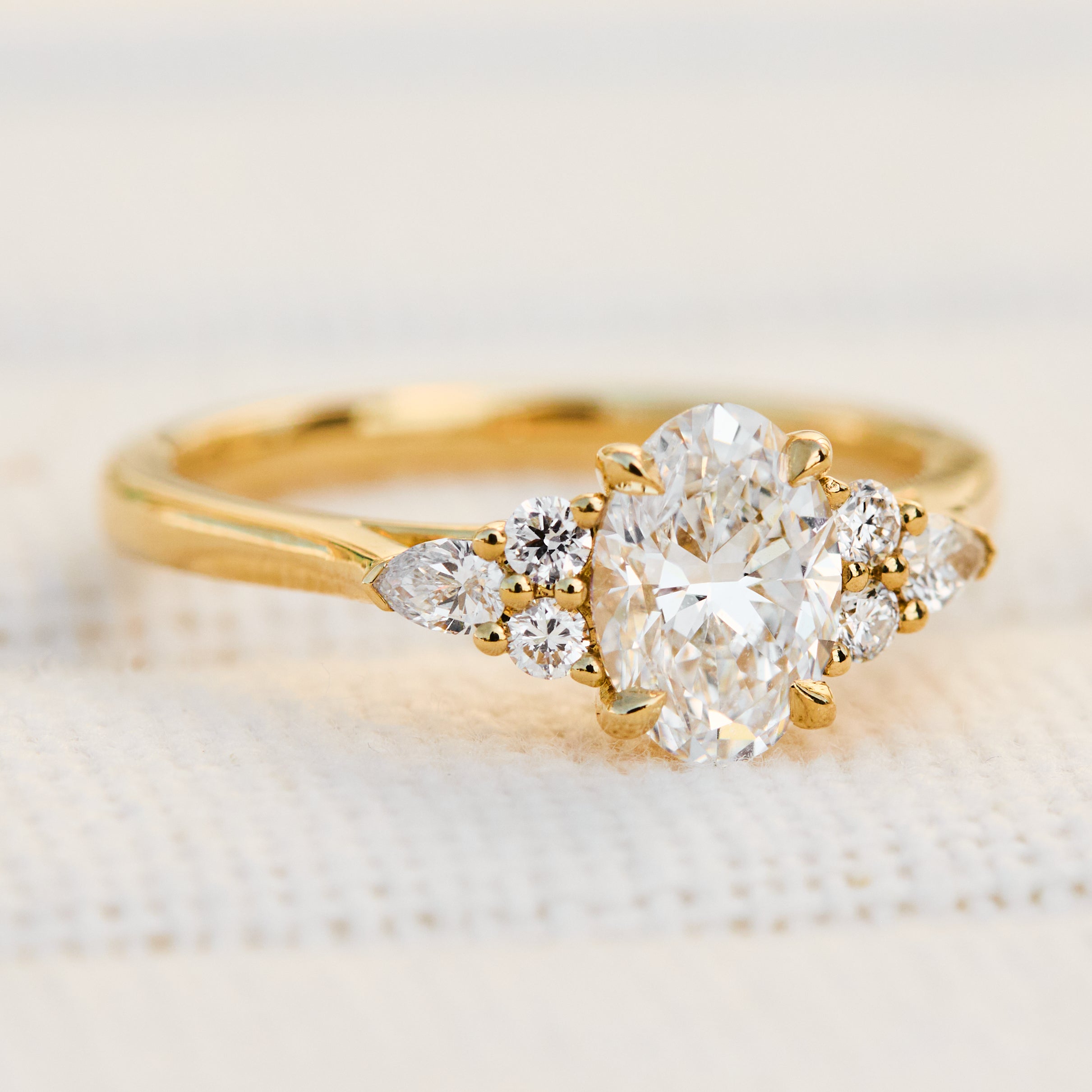 oval lab grown diamond engagement ring set in 18ct yellow gold