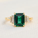 lab grown emerald and diamonds engagement ring set in yellow gold
