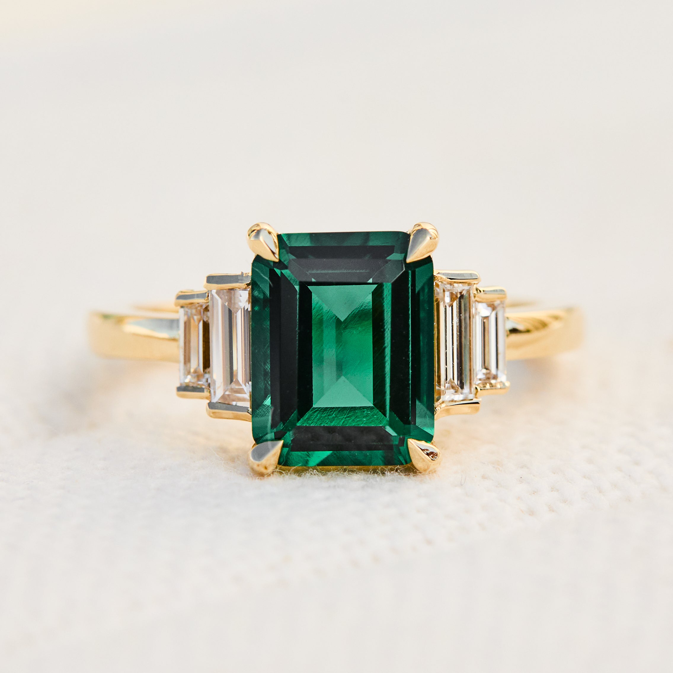 lab grown emerald and diamonds engagement ring set in yellow gold