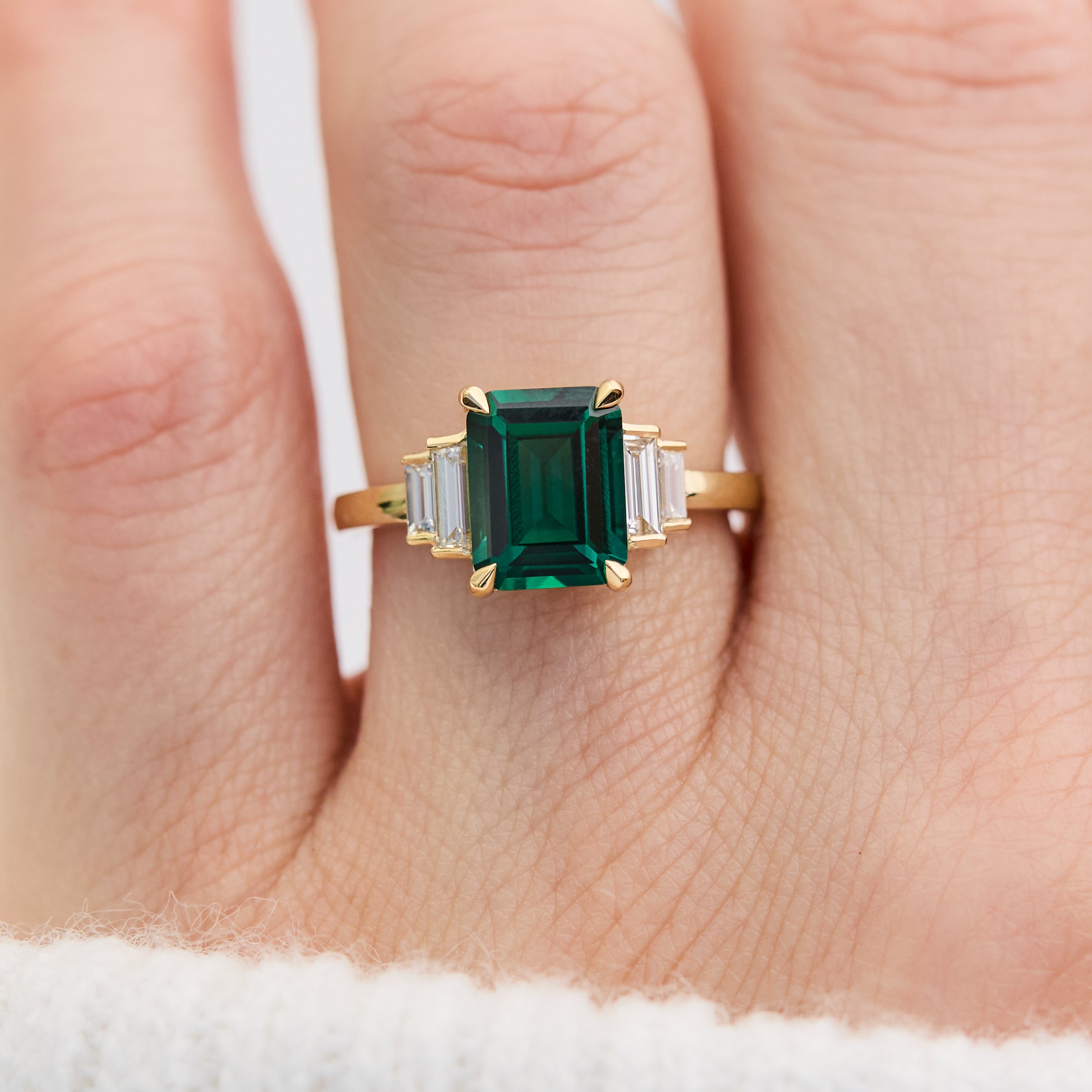 lab grown emerald and diamonds engagement ring set in yellow gold