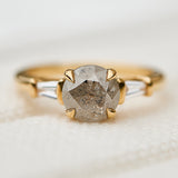 light grey round salt and pepper diamond trilogy engagement ring in yellow gold