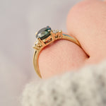 australian oval teal sapphire engagement ring with round diamond side stones