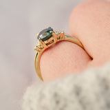 australian oval teal sapphire engagement ring with round diamond side stones