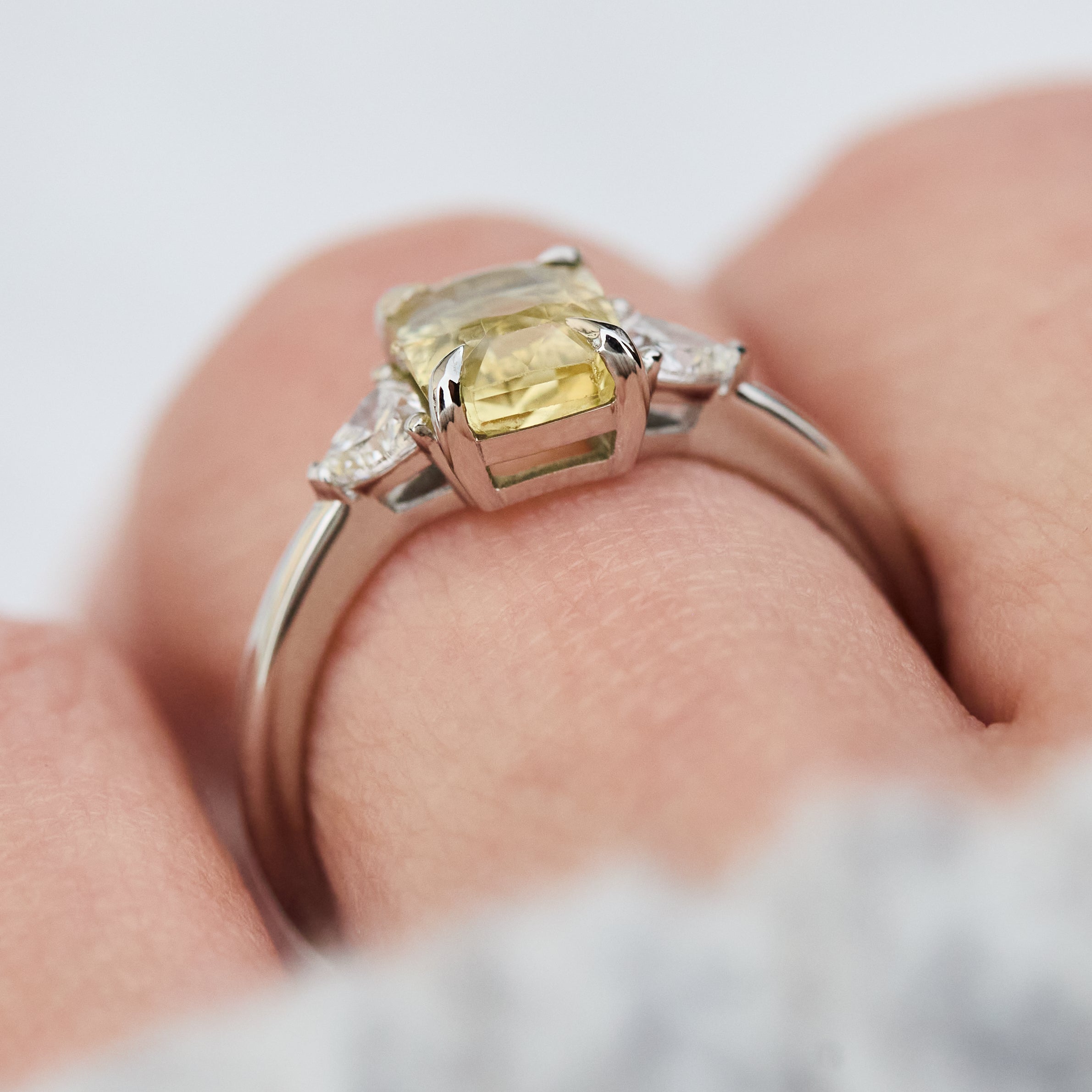 cushion cut yellow sapphire platinum trilogy engagement ring