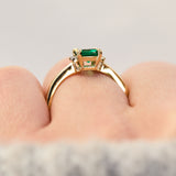 emerald cut emerald trilogy engagement ring set in yellow gold