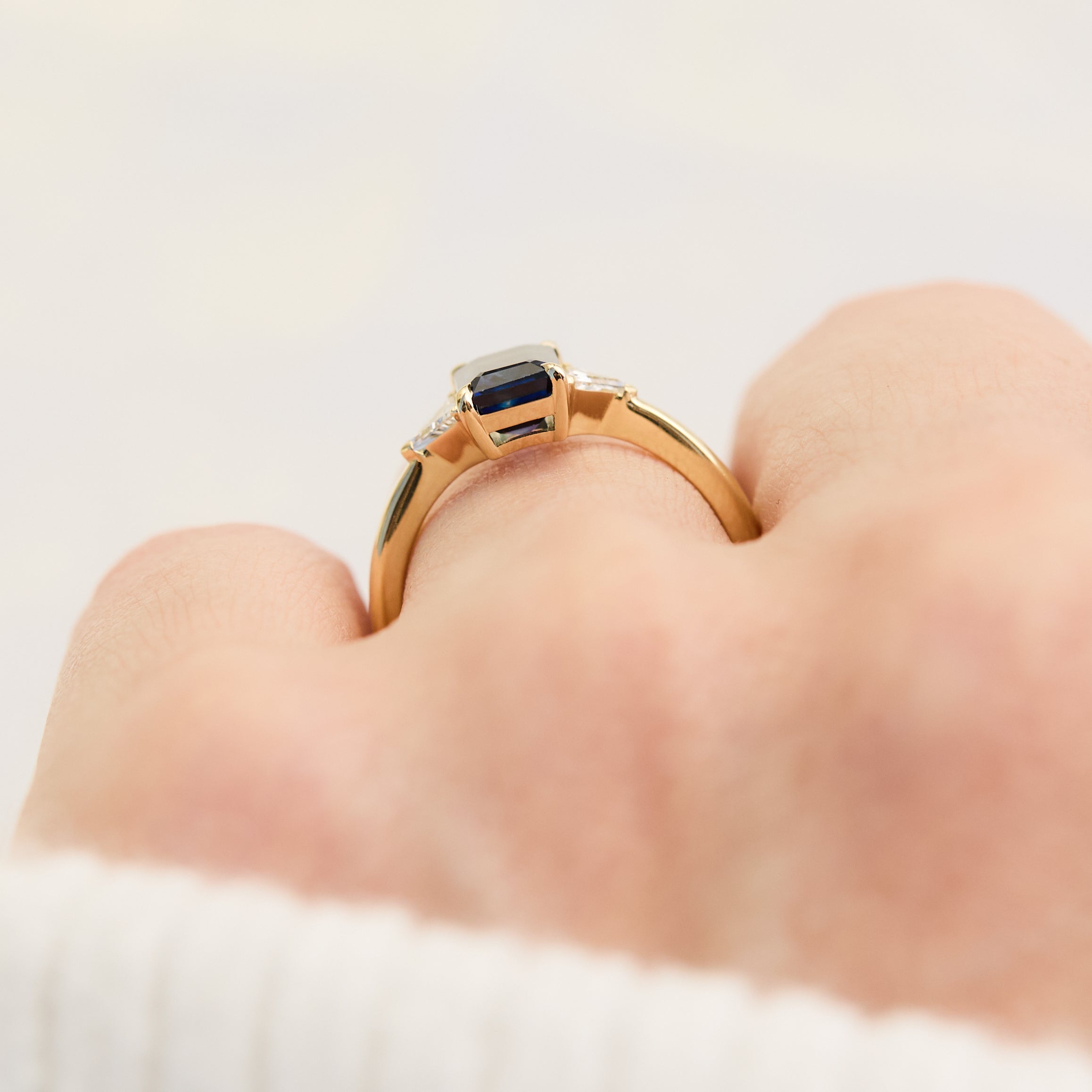 emerald cut sapphire trilogy engagement ring in yellow gold