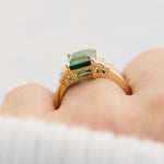 lab grown emerald and diamonds engagement ring set in yellow gold