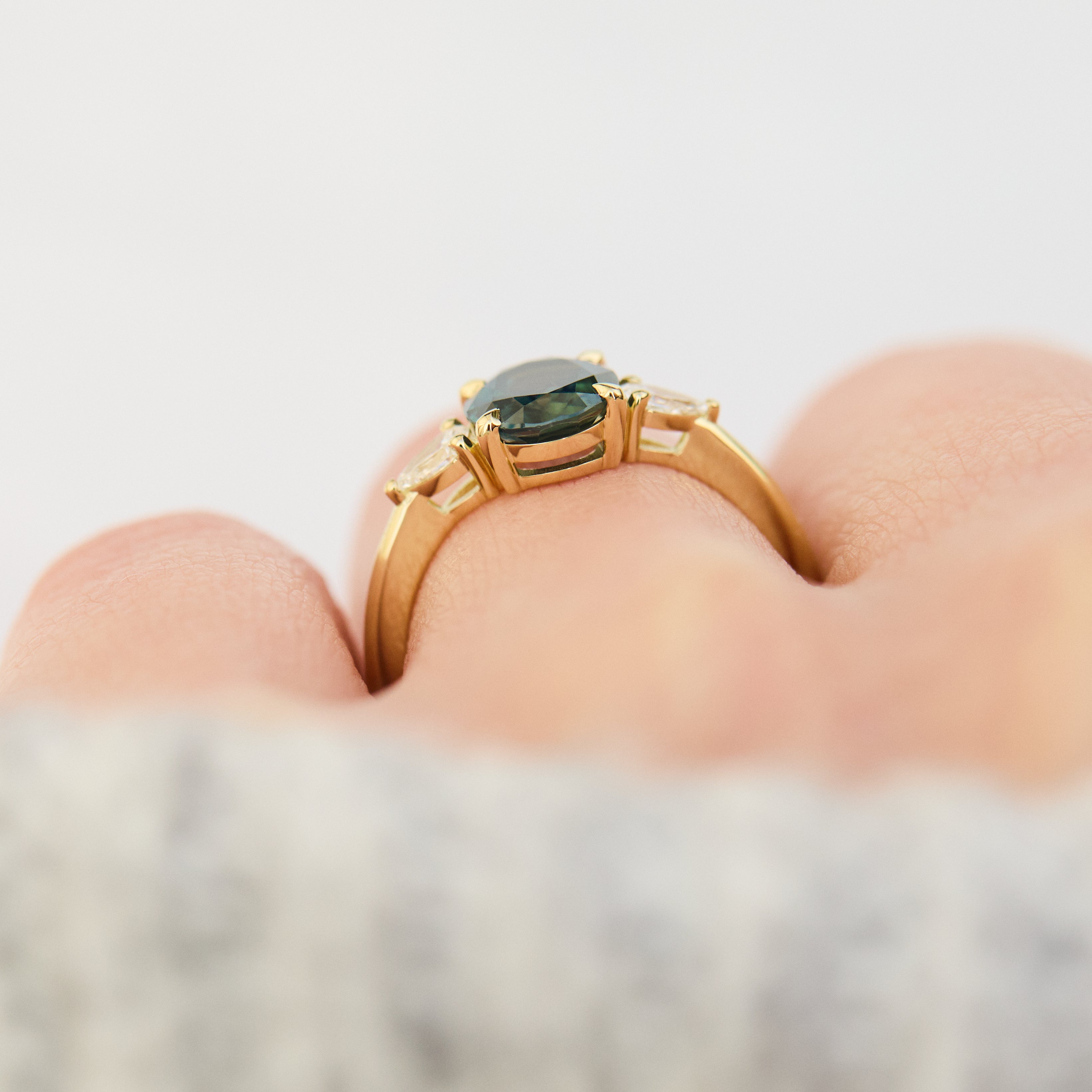 oval australian teal sapphire trilogy engagement ring in yellow gold