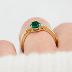 oval emerald yellow gold engagement ring with six round side diamonds