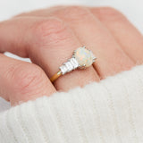 oval opal and diamond engagement ring set in yellow gold and platinum