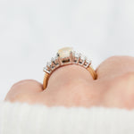 oval opal and diamond engagement ring set in yellow gold and platinum