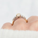 oval opal and diamond engagement ring set in yellow gold and platinum