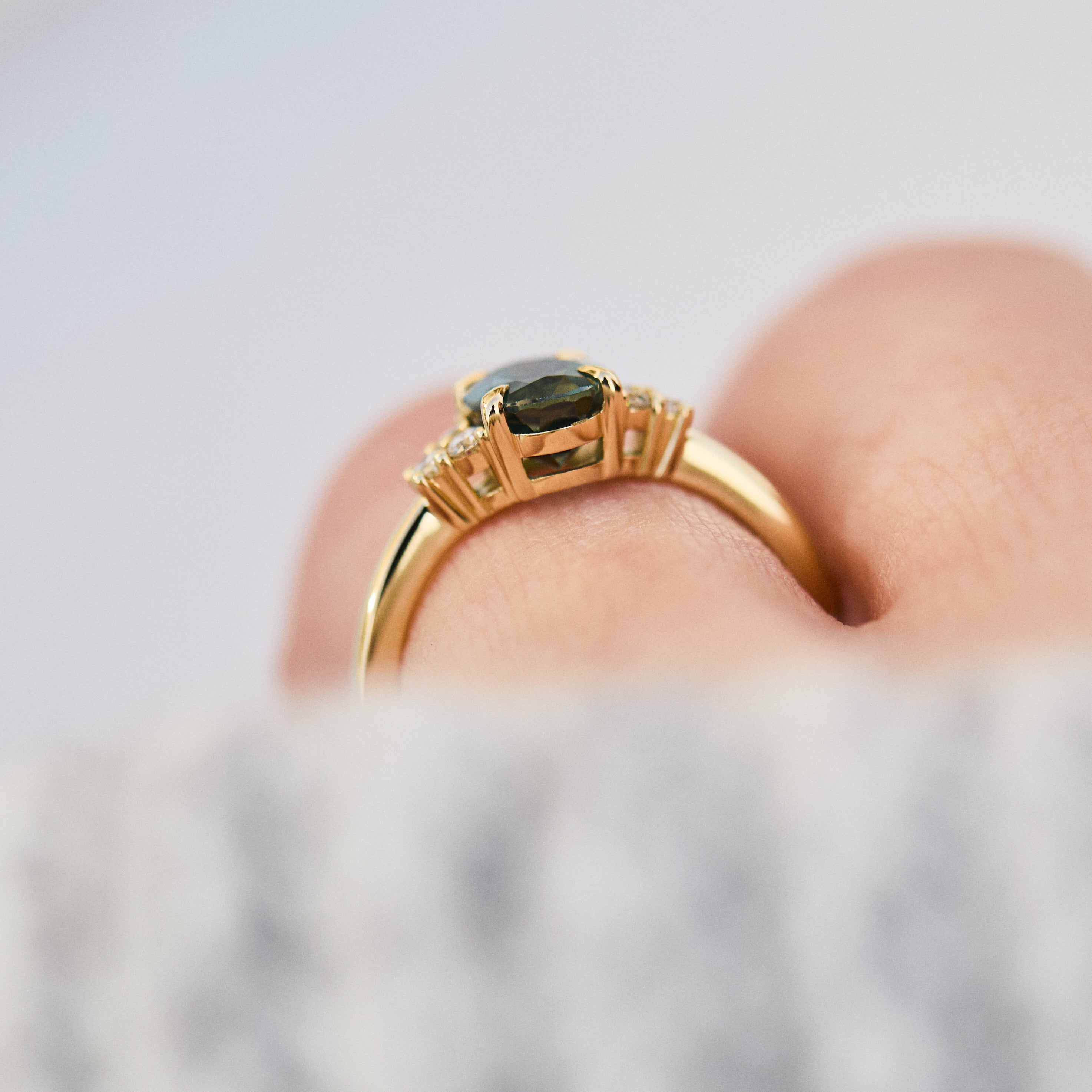 oval teal green sapphire and diamonds yellow gold engagement ring