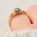 pear shape blue teal sapphire engagement ring set in yellow gold